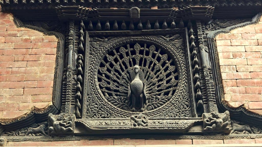 The Peacock Window — 15th-century wood carving in the Pujari Math, Bhaktapur